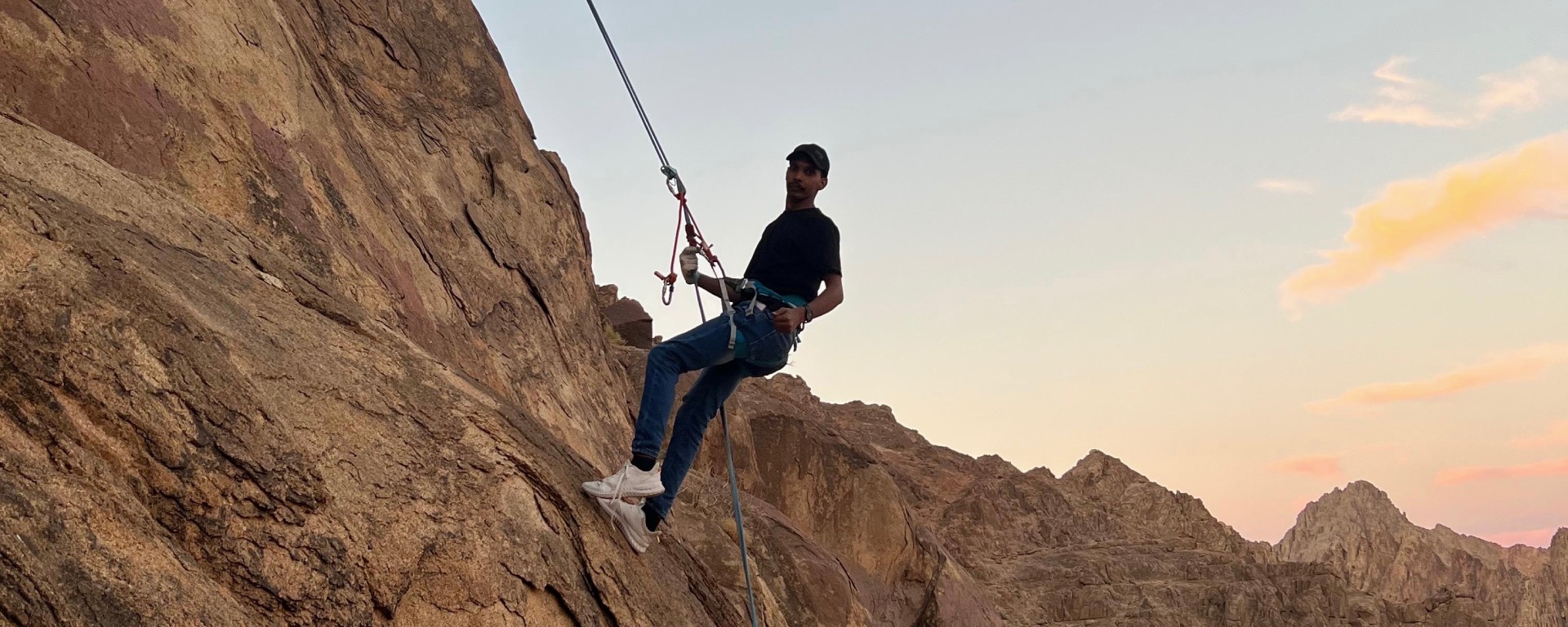 Rappelling (going down mountain rocks with a rope)